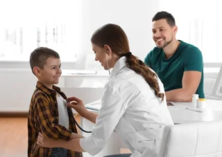 Father son visiting pediatrician doctor